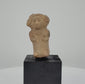 360-degree rotating video of an ancient seated female terracotta figurine from Veracruz, Mexico, circa 600–900 CE, featuring an elaborate headdress, detailed facial features, decorative necklace, and sculpted hands resting on the torso. A Pre-Columbian artifact with natural earthen patina.