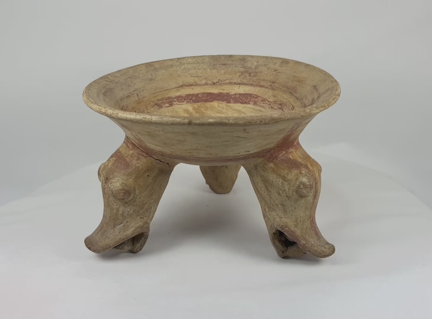 Rotating view of ancient tripod bowl with zoomorphic supports and ochre slip, Nicoya culture, 800–1200 AD