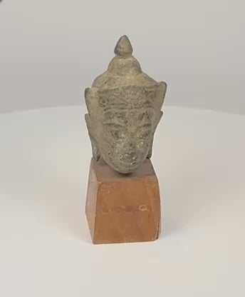 Thai bronze Buddha head with serene facial features, elongated earlobes, pointed ushnisha and naturally aged patina