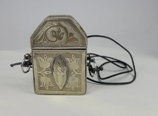 19th century Tibetan silver repoussé gau amulet box, hinged portable shrine with floral and symbolic motifs, original leather strap remnants, Himalayan devotional artifact
