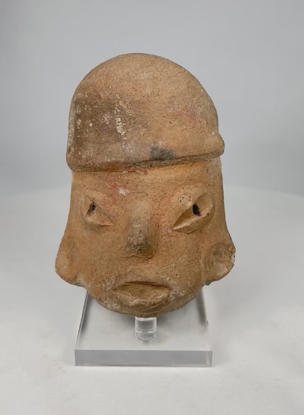 Rotating view of a Pre-Columbian terracotta sculptural head with hollow rear opening, stylized facial features, and archaeological patina, circa 300 BCE–900 CE.