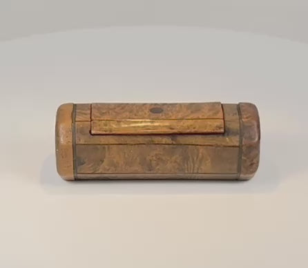 360-degree rotating view of a 19th-century British burr walnut snuff box, showing the figured wood grain, dark stringing, hinged lid, faceted sides, rounded ends, and aged patina.