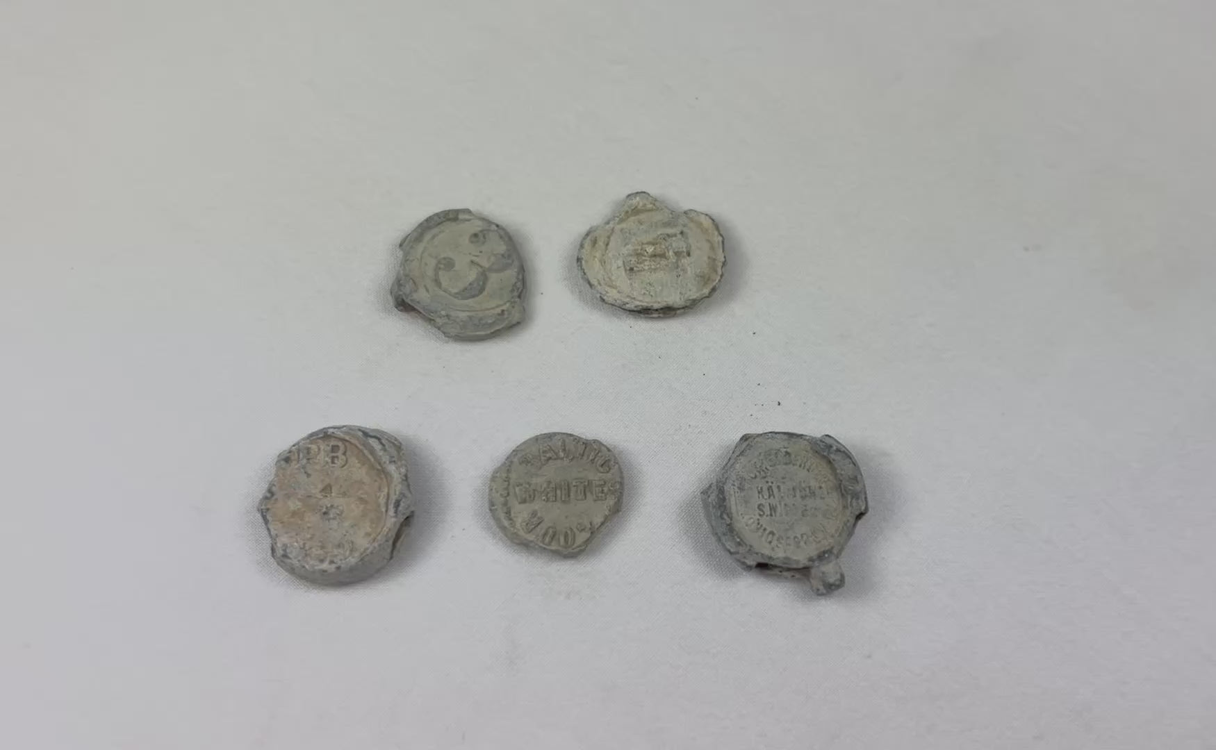 Set of five 18th–19th century English copper trade tokens recovered from shipwreck, heavily encrusted with marine patina, used in colonial trade and merchant commerce, historic maritime artifact