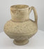 360-degree rotating view of a medieval Persian Seljuk-style pottery ewer, attributed to the 12th–13th century CE, featuring raised horse-like animal figures, heart-shaped ornamental motifs, decorative medallions, a rounded body, flared neck, curved handle, and aged buff-coloured earthenware surface.