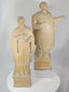 360-degree rotating view of a pair of antique hand-carved European religious wooden sculptures depicting saintly and ecclesiastical figures. The carvings feature detailed vestments, expressive facial features, integral pedestal bases, and a rich aged patina characteristic of 18th–19th century devotional art.