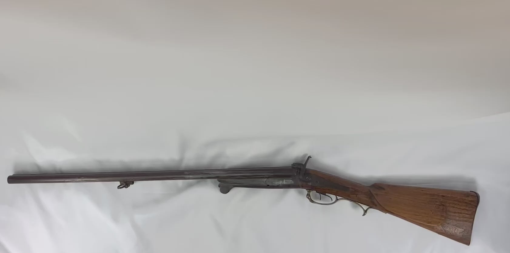 Antique French underlever double-barrel shotgun, 16 bore, mid-19th century, pinfire ignition system, walnut stock with brass trigger guard, non-functional collector’s piece