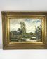 Antique early 20th-century Impressionist-style oil painting depicting a peaceful European river landscape with a solitary figure rowing a wooden boat, tall trees, lush greenery, and reflective water beneath a blue, cloud-filled sky. Presented in an ornate gilt frame with decorative foliate detailing.