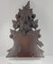Antique Black Forest-style carved wood furniture crest shown in detail, highlighting the fruit basket, foliage, pierced carving, aged patina, mounting points and historic repairs.