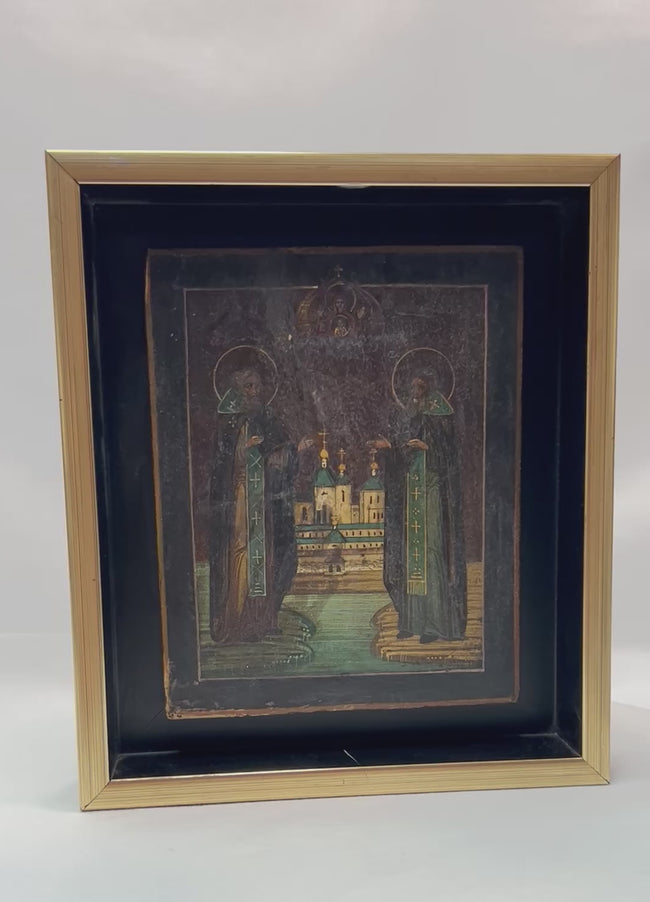 360-degree presentation of an antique Russian Orthodox icon depicting Saints Zosima and Savvaty with the Solovetsky Monastery, showing fine detailing, rich color tones, gilded highlights, and framed museum-style display