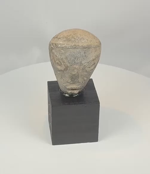 360-degree rotating video of an ancient Mesopotamian pottery head mounted on a custom display stand, circa 2000–1500 BCE
