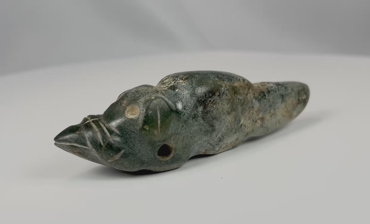 Pre-Columbian greenstone animal effigy pendant rotating view showing carved details and perforation