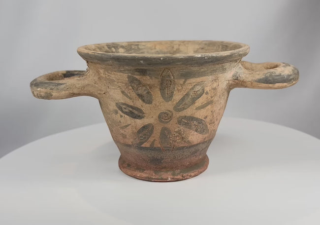 Video showcasing ancient Etruscan terracotta skyphos with rosette decoration twin handles and aged burial patina from multiple angles