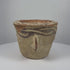 Ancient Afghan terracotta mortar dating to the 12th century CE during the Islamic Golden Age, featuring decorative black slip motifs around the rim, projecting side handles, a rounded grinding compartment, natural interior abrasions, warm earthen patina, and traditional medieval Islamic pottery craftsmanship.