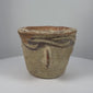 Ancient Afghan terracotta mortar dating to the 12th century CE during the Islamic Golden Age, featuring decorative black slip motifs around the rim, projecting side handles, a rounded grinding compartment, natural interior abrasions, warm earthen patina, and traditional medieval Islamic pottery craftsmanship.