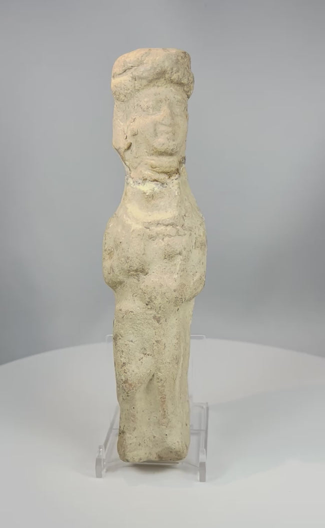 Video showcasing ancient Mesopotamian terracotta female figurine with folded arms mineral patina and stylized form from multiple angles