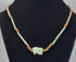 360-degree rotating view of an ancient Egyptian-style faience necklace featuring a turquoise-green Eye of Horus (Wedjat) amulet, elongated tubular beads, and earthy brown disc-shaped spacers. The video highlights the protective eye symbol, aged surfaces, intricate bead arrangement, and distinctive blue-green coloration from multiple angles.