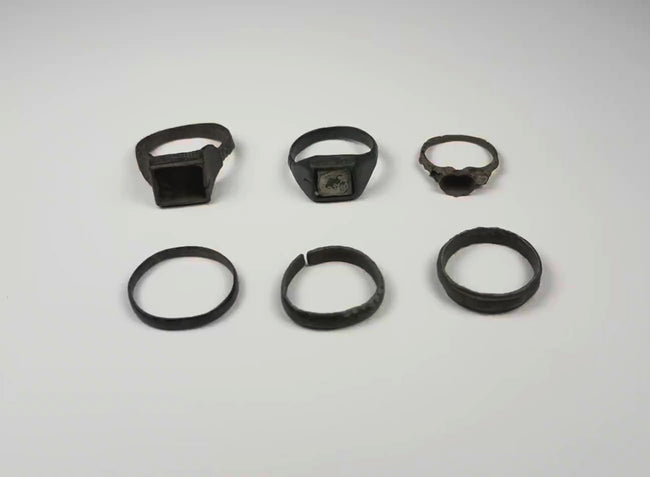 Video showing a group of six Late Roman to Early Byzantine bronze finger rings from multiple angles, circa 3rd–7th century CE