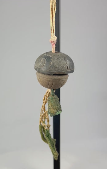360-degree rotating view of an ancient bronze ritual bell pendant with original fiber cord, verdigris patina, and intact clapper
