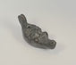 Rotating view of an antique grotesque satyr-form oil lamp featuring a cast metal mythological mask, filling aperture, wick nozzle, suspension holes, and dark aged patina, Europe, 19th century.