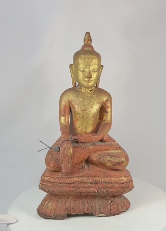 Large antique Burmese Shan-style Buddha statue with original gilt finish, seated in dhyana mudra on a tiered lotus base. 19th-century Southeast Asian devotional sculpture showing serene expression, aged surface, and traces of red lacquer beneath gold.