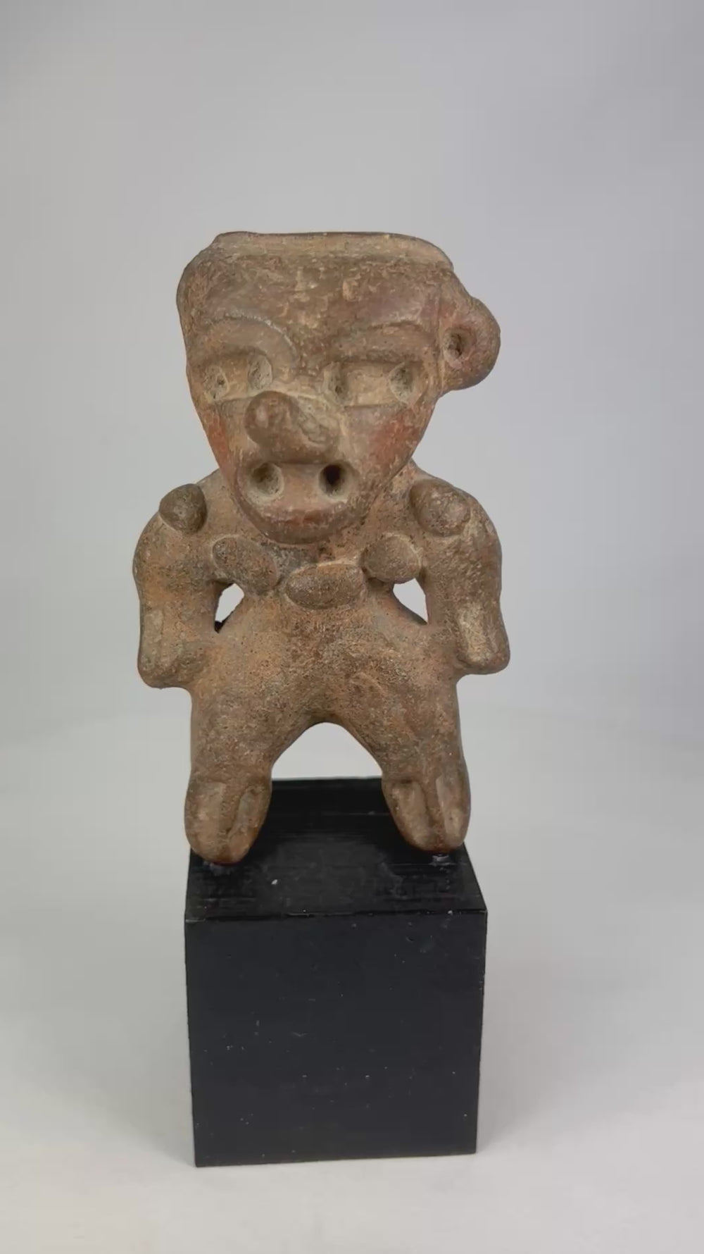 360-degree video of a Pre-Columbian West Mexican terracotta standing figure, highlighting stylized features, burial patina, and shaft-tomb sculptural form