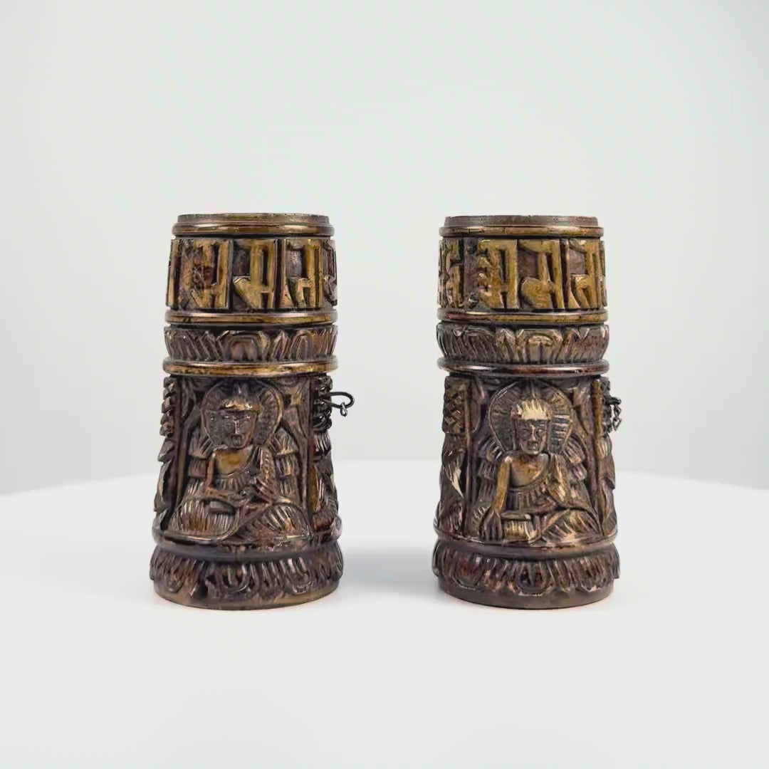 Video of pair of Tibetan Buddhist prayer wheels carved from human femur bone with Buddha relief figures and Sanskrit inscriptions