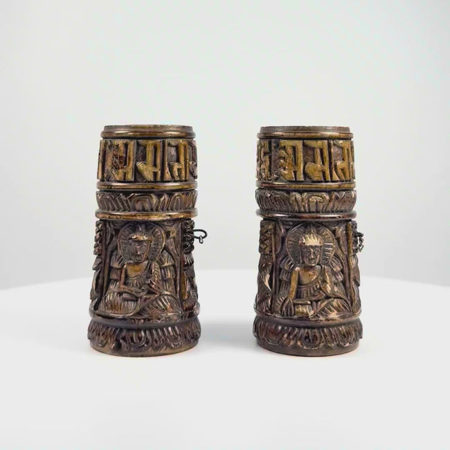 Video of pair of Tibetan Buddhist prayer wheels carved from human femur bone with Buddha relief figures and Sanskrit inscriptions
