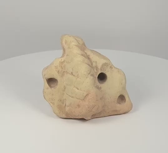 360-degree rotating view of a Pre-Columbian Taíno three-pointed stone zemi, showing the central projection, carved apertures, abstract sculptural form, and weathered pale stone surface.