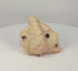 360-degree rotating view of a Pre-Columbian Taíno three-pointed stone zemi, showing the central projection, carved apertures, abstract sculptural form, and weathered pale stone surface.