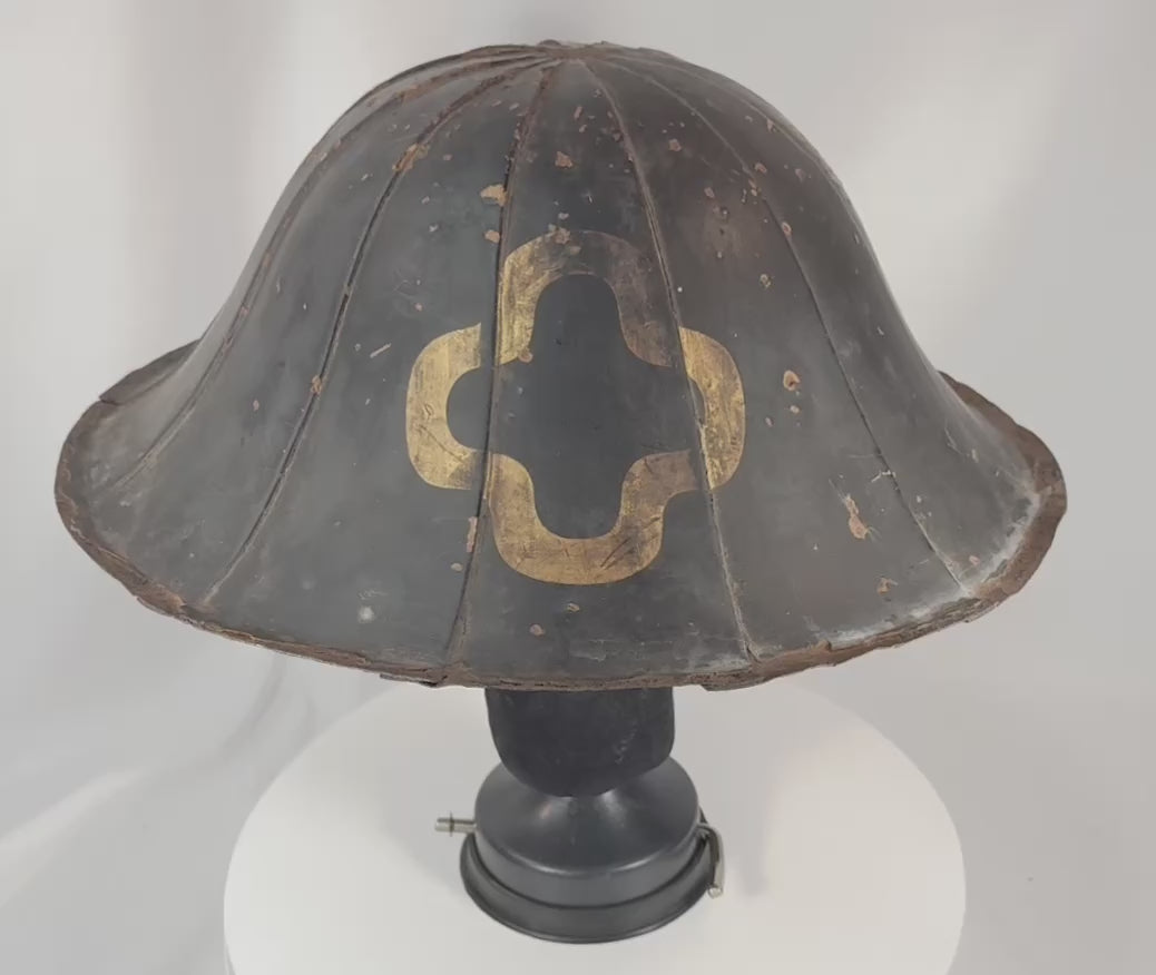 360-degree view of an antique Edo period Japanese jingasa samurai helmet with black lacquer finish, gilt mon crest, broad flared brim, and aged red lacquer interior