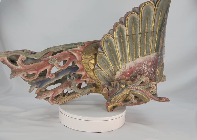 Video showing a mid-19th-century Chinese phoenix architectural carving in hand-carved camphor wood, with raised wings, detailed plumage, polychrome red, green, and blue pigments, gilded highlights, and natural age-related patina.