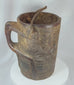 360-degree view of an antique Himalayan carved wooden storage vessel featuring geometric relief carving, an integrated side handle, original fiber rope suspension handle, and rich aged patina.