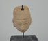 360-degree rotating video of an ancient Mesoamerican terracotta clay amulet head attributed to the Colima or Nayarit region of West Mexico, circa 300 BCE–300 CE. Pre-Columbian artifact showcasing traditional sculptural craftsmanship and age-related surface wear.