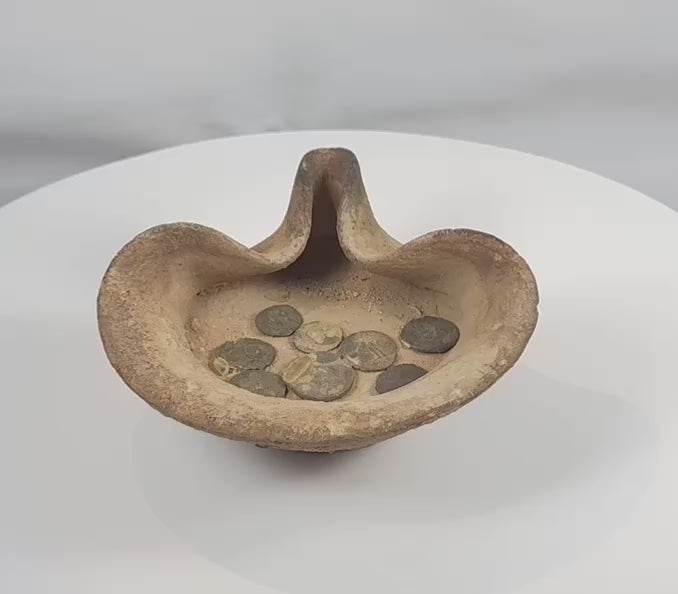 360-degree view of an ancient Carthaginian terracotta saucer-shaped oil lamp with associated bronze coins from Carthage, dating circa 5th Century BCE–1st Century AD, showing archaeological surfaces, folded rim construction, and authentic age-related patina.