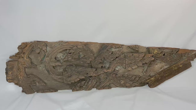 17th-century Thai Ayutthaya carved wooden temple fragment with flowing motifs, remnants of gilding, and symmetrical sacred design.