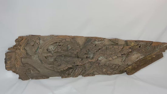 17th-century Thai Ayutthaya carved wooden temple fragment with flowing motifs, remnants of gilding, and symmetrical sacred design.