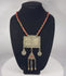 Antique Turkmen tribal necklace featuring a large rectangular pectoral pendant, triangular tumar amulet, silver-toned metal, red glass beads, suspended coin elements, and handcrafted Central Asian ceremonial craftsmanship dating to the late 19th or early 20th century.