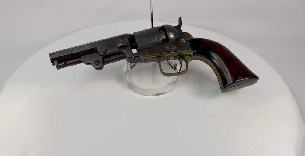 Antique Colt 1849 Pocket Revolver from 1859 showcasing original walnut grip, brass frame, and Stagecoach Scene cylinder — authentic 19th-century Colt firearm.