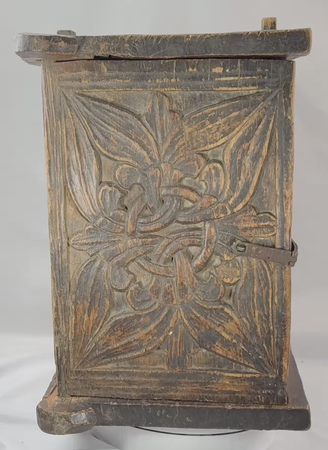 Video presenting the carved floral decoration, iron hardware, interior, and construction of an antique South Asian wooden chest