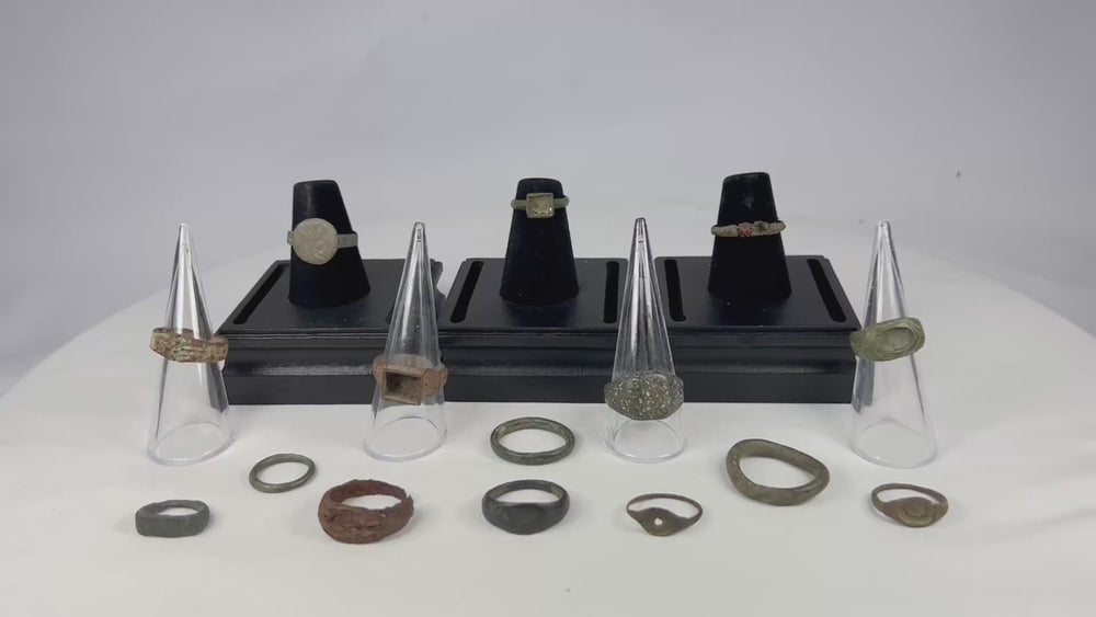 A curated collection of fifteen ancient bronze rings spanning Egypt, Rome, Byzantium, Viking, and Medieval Europe, featuring diverse patinas, signet bezels, wedding bands, and ceremonial designs, dating from 1000 BCE to the 15th century CE.