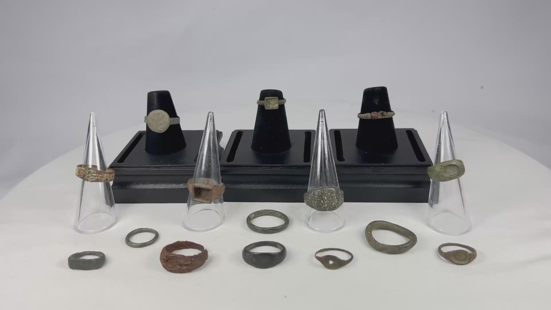 A curated collection of fifteen ancient bronze rings spanning Egypt, Rome, Byzantium, Viking, and Medieval Europe, featuring diverse patinas, signet bezels, wedding bands, and ceremonial designs, dating from 1000 BCE to the 15th century CE.