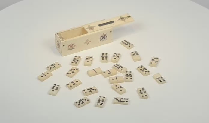 Rotating video of an antique miniature bone domino set and decorated sliding-lid case, circa 1800–1850