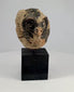 Rotating 360° video showing an ancient Mesoamerican terracotta mask fragment.