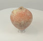 Video showing an ancient Roman terracotta feeding or dispensing vessel with a globular body, small handle and missing tubular spout