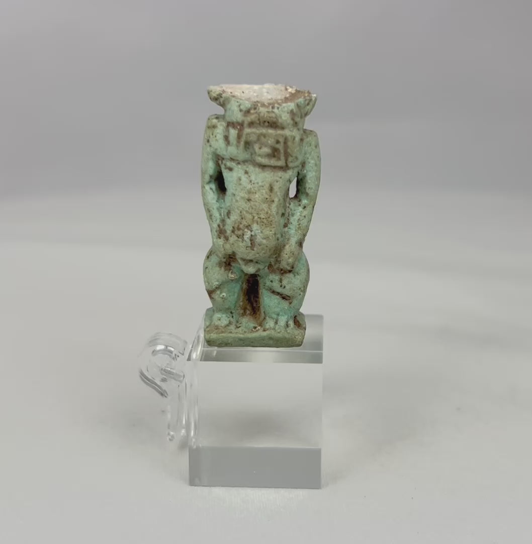 Rotating video of an ancient Egyptian blue faience Bes protective deity amulet.
