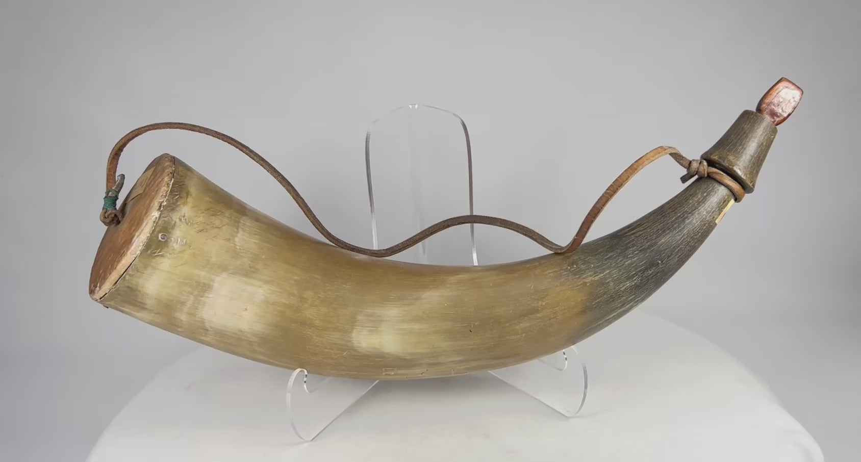 360-degree video of an authentic 19th-century North American antique powder horn showing full body shape, wood plug, leather strap, aged patina, and collection label