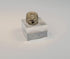 Rotating view of a cream-colored ancient Egyptian faience scarab amulet with mineral accretions