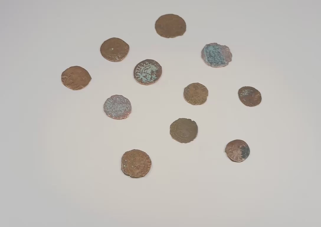 Video presentation of eleven medieval Crusader bronze coins showing both sides, religious motifs, inscriptions, and natural patina