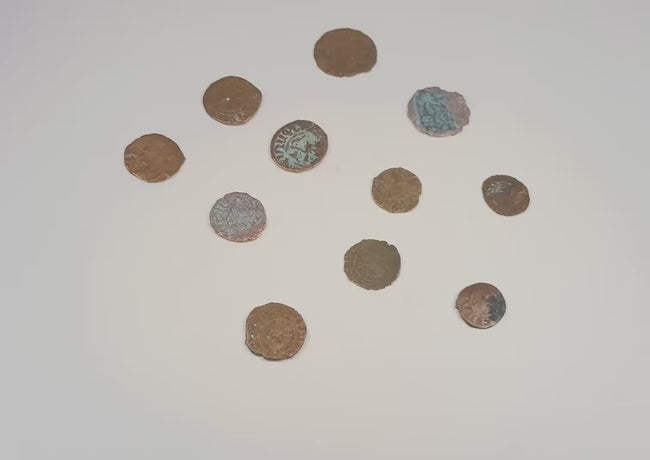 Video presentation of eleven medieval Crusader bronze coins showing both sides, religious motifs, inscriptions, and natural patina