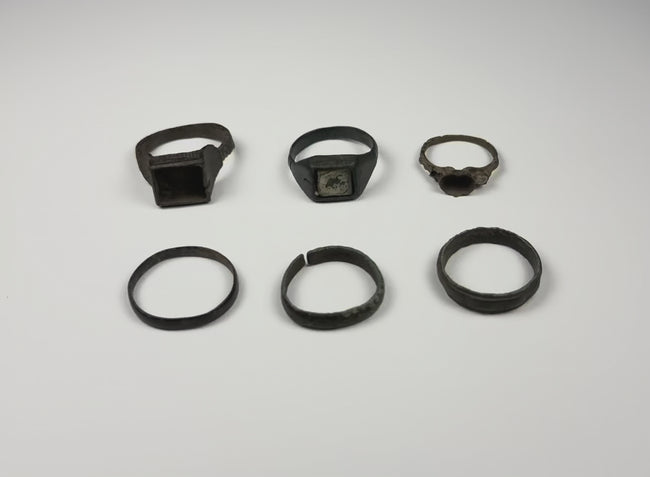 Video showing a group of six Late Roman to Early Byzantine bronze finger rings from multiple angles, circa 3rd–7th century CE